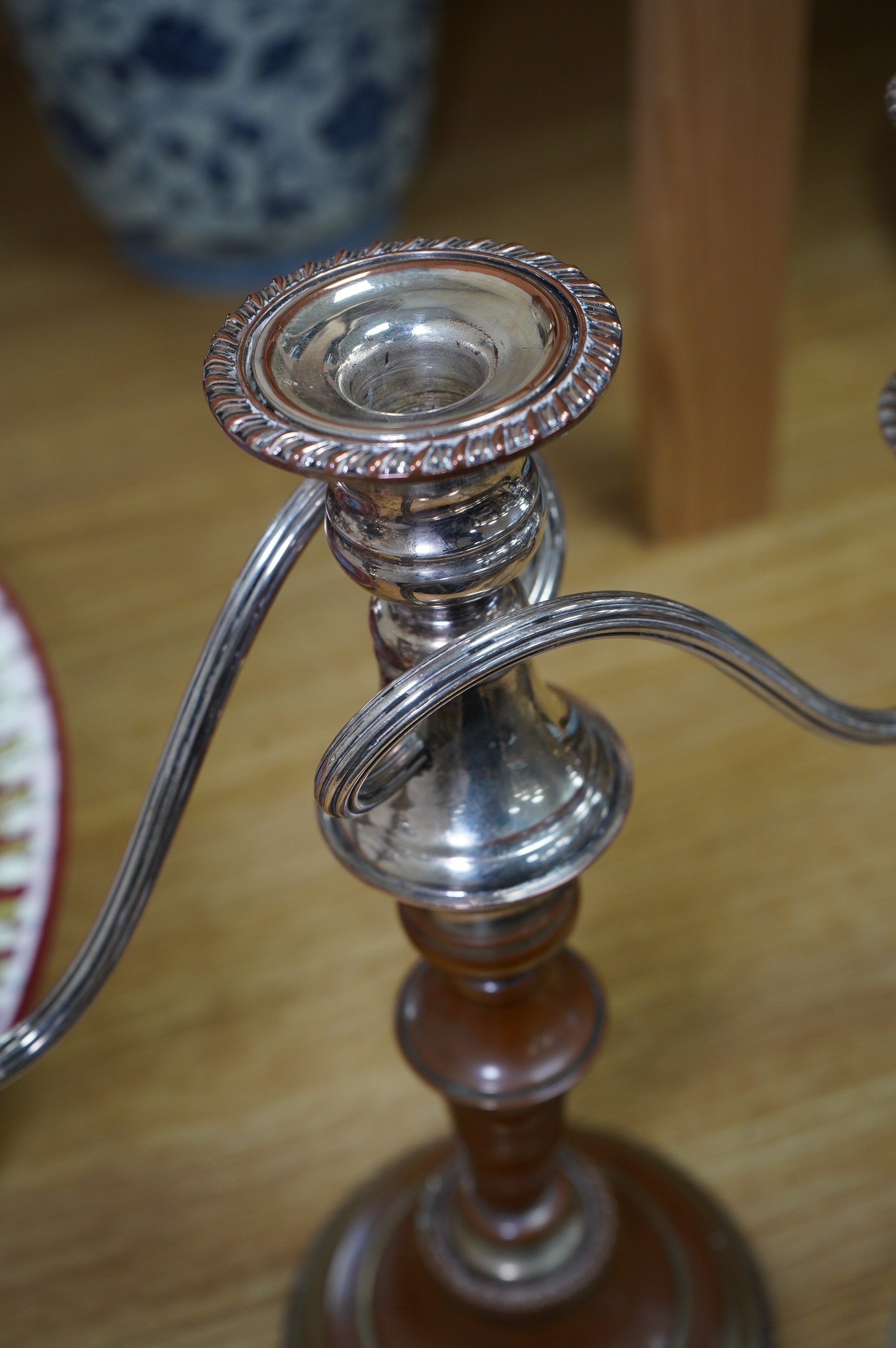 A Victorian silver plated claret jug, together with a pair of candelabra, 30cm. Condition - worn